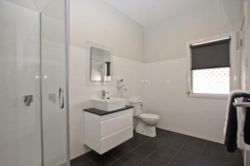 a white bathroom with a sink and a toilet at Jesmond Affordable Apartments in Jesmond