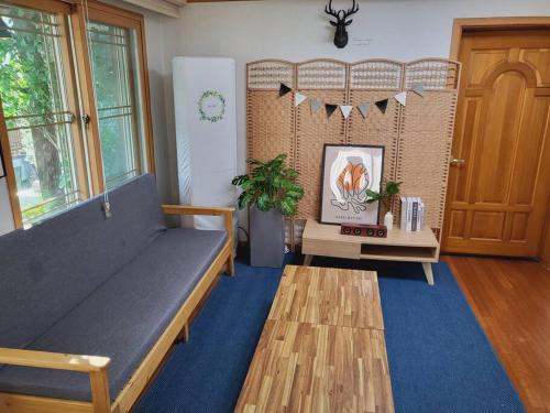 a living room with a bench and a blue rug at Urban forest #terminal 5min #baseball stadium 2min in Gwangju