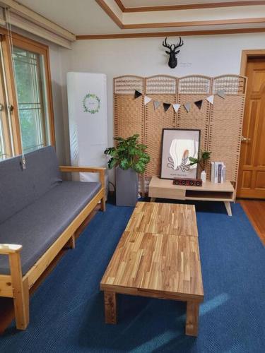 a living room with a couch and a coffee table at Urban forest #terminal 5min #baseball stadium 2min in Gwangju