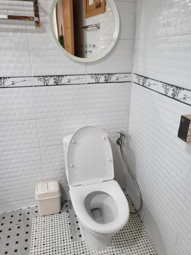 a bathroom with a white toilet and a mirror at Urban forest #terminal 5min #baseball stadium 2min in Gwangju