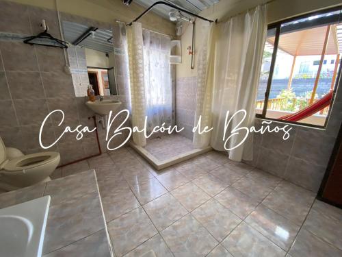 a bathroom with two toilets and a shower with a window at Casa Balcón de Baños in Baños