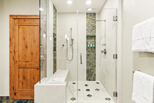 a bathroom with a shower with a glass door at Slope-side Oasis Premium Snowmass Mountain Condo in Snowmass Village