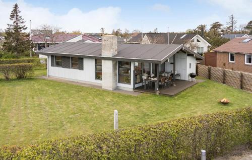 a white house with a patio and a yard at Awesome Home In Børkop in Børkop
