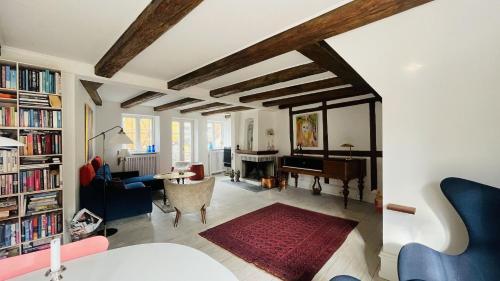 a living room with a table and a piano at ApartmentInCopenhagen Apartment 1631 in Copenhagen