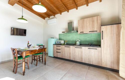 a kitchen with a wooden table and a dining room at Casa Muzzi Verde in Casole dʼElsa