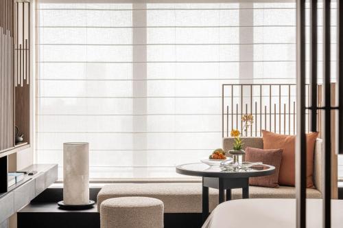 a living room with a couch and a table at Four Seasons Hotel Osaka in Osaka
