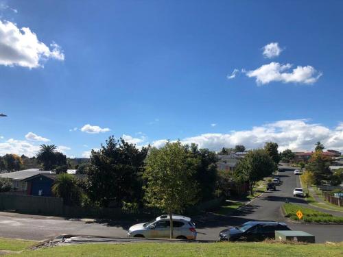 a street with cars parked in a parking lot at Location, luxury and stylish comfort in Hamilton