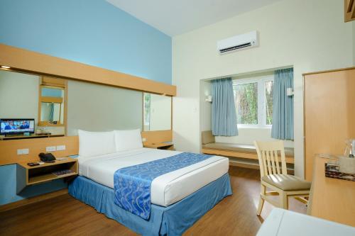 Postel nebo postele na pokoji v ubytování Microtel by Wyndham Davao