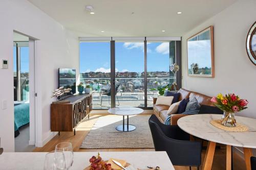a living room with a couch and a table at 1 Bedroom Apartment With Parking Close To Beach in Williamstown