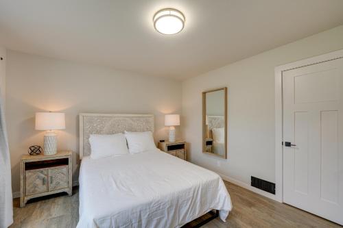 a white bedroom with a bed and two night stands at Oak Harbor Vacation Rental in Oak Harbor