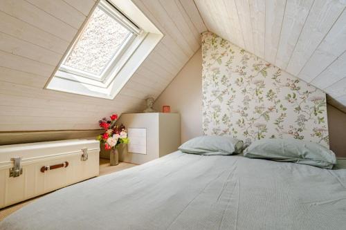 a bedroom with a large bed in a attic at Countryside Cottage samois-sur-seine in Samois-sur-Seine