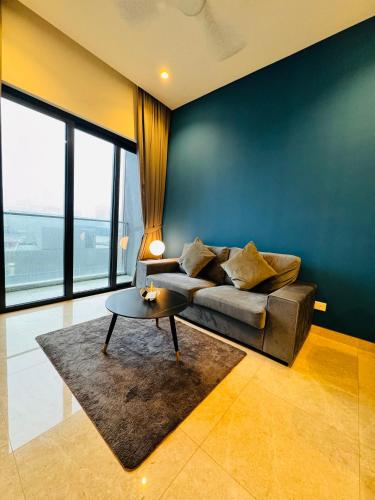 a living room with a couch and a table at LUCENTIA RESIDENCE By LALAPORT in Kuala Lumpur