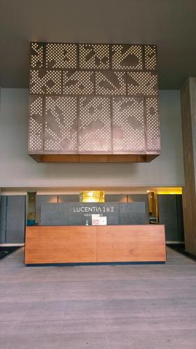 a lobby with a reception desk in a building at LUCENTIA RESIDENCE By LALAPORT in Kuala Lumpur