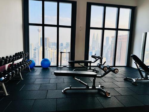a gym with a view of a city skyline at LUCENTIA RESIDENCE By LALAPORT in Kuala Lumpur