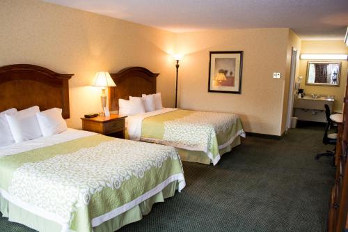 a hotel room with two beds and a desk at Days Inn by Wyndham Klamath Falls in Klamath Falls