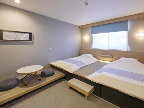 Postel nebo postele na pokoji v ubytování Hotel Rotterdam Huis Ten Bosch