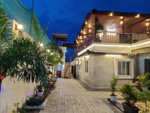 a courtyard of a house with plants and lights at Raj Heritage in Murbād