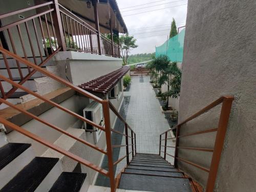 a stairway leading up to a building with stairs at Raj Heritage in Murbād