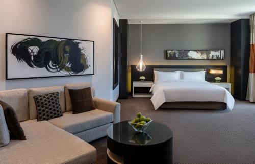 a hotel room with a bed and a couch at Fairmont Riyadh in Riyadh