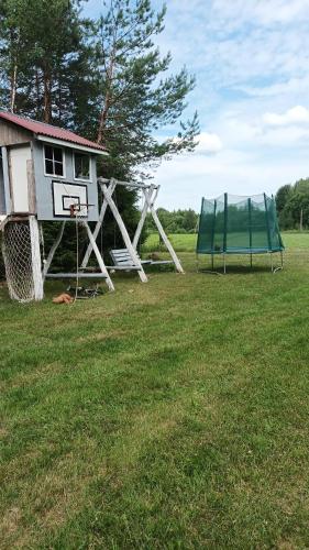 a house with a basketball hoop and a net at Malinada-kaimo sodyba in Šalčininkai