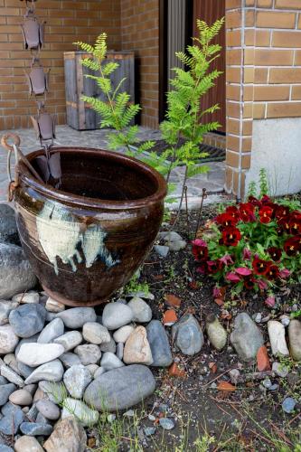 a large pot sitting on a pile of rocks at Nonna Milli in Matsumoto