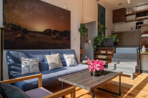 a living room with a blue couch and a table at Deluxe Apartment W Private Terrace Reforma Av in Mexico City
