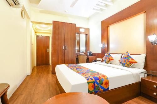 a bedroom with a large bed in a room at FabHotel Shubhangan in Mumbai