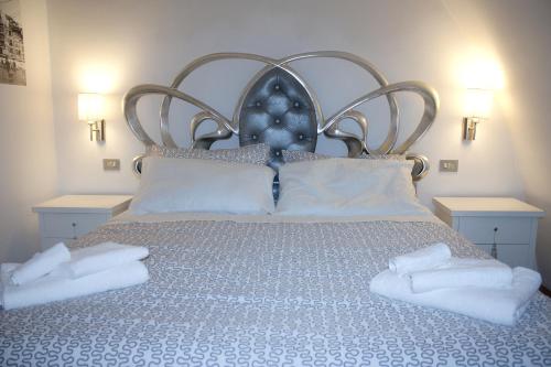 a bedroom with a bed with white towels on it at Antica Dimora Julia in Spello