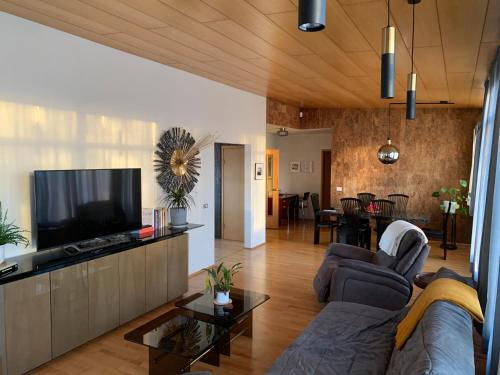a living room with a couch and a flat screen tv at 3BR Keflavík Home, 8 Min to Airport Sleeps 6 in Keflavík