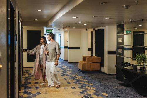 a man and a woman standing in a lobby at Cinnamon Lakeside in Colombo