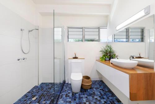 a bathroom with a toilet and a sink at 'Arafura Blue' a Poolside Family Oasis on the Coast in Darwin