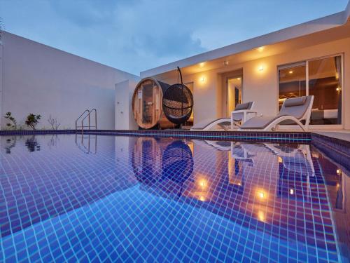 a swimming pool in a villa with aigiligiligiligiligil at The Pool & Sauna Villa MOTOBU in Motobu