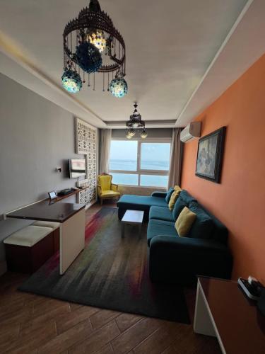 a living room with a couch and a table at Downtown Sea View Suites in Alexandria