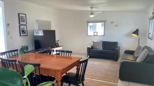 a living room with a table and chairs and a couch at Close to Water, Restaurants and Clubs, Toorbul St, Bongaree in Bongaree