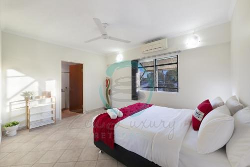 a bedroom with a large bed in a room at ZEN FORESHORE: 3-BR Nightcliff Foreshore-Front Apt in Nightcliff