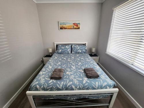 a small bedroom with a bed with two pillows at Unit 51 Seafront Estate in Jurien Bay