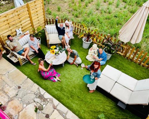 a group of people sitting on the grass at Apartamentos la Jayma del Arte in Asque