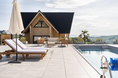 a villa with a swimming pool and a house at Chaletovo Mountain Residences in Zakopane