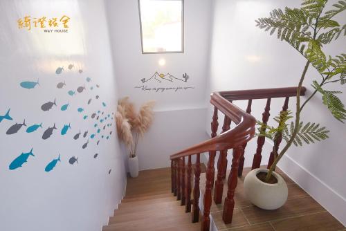 a staircase with a potted plant in a room at 寮寓x綺澄 in Xiaoliuqiu