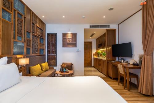 a hotel room with a bed and a kitchen at Bonny Boutique Hotel Da Nang in Da Nang