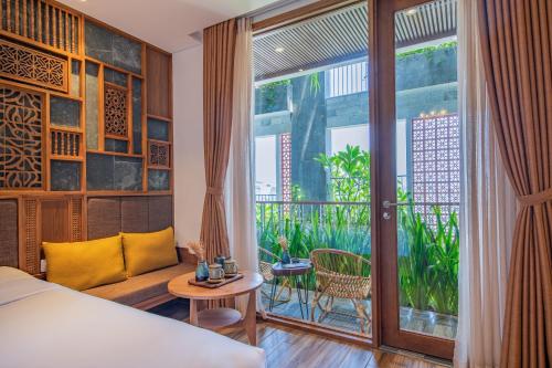 a hotel room with a bed and a large window at Bonny Boutique Hotel Da Nang in Da Nang