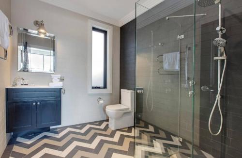 a bathroom with a toilet and a glass shower at Perfect Located 2-Bed Blue Mountains Getaway in Katoomba