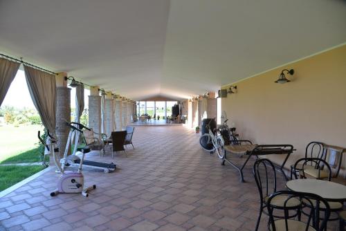 a room with tables and chairs and a room with bikes at La Tenuta del Passero in Le Ferriere