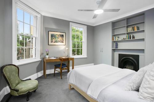 a bedroom with a bed and a desk and a chair at Family Terrace Home Close to Oxford Street and CBD in Sydney