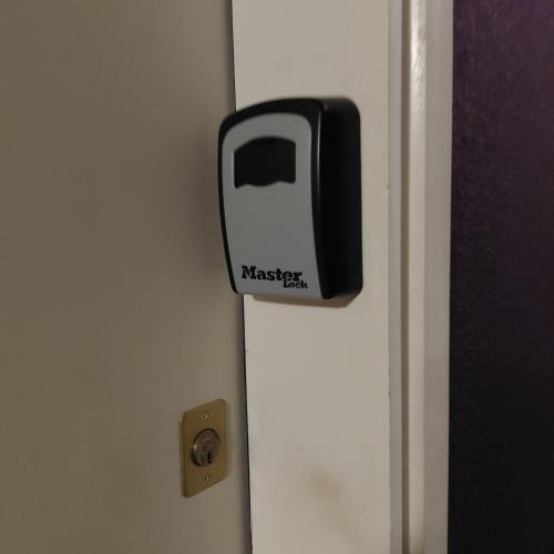 a door with a black and white appliance on it at La Pause Valognaise "Parking privé" in Valognes