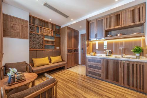 a kitchen and living room with a couch and a table at Bonny Boutique Hotel Da Nang in Da Nang