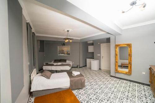 a hotel room with two beds and a mirror at HHK Hotel in Istanbul