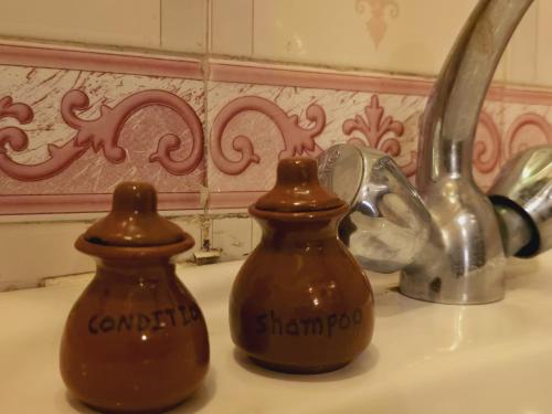 two brown bottles sitting on top of a sink at Cascade Hotel in Kathmandu