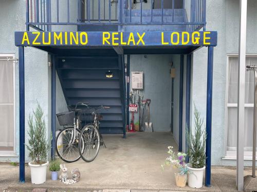 a bike parked under a garage with a sign at Azumi Relax Lodge201 in Azumino