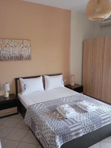 a bedroom with a bed with two towels on it at Miranda Studios in Paliouri
